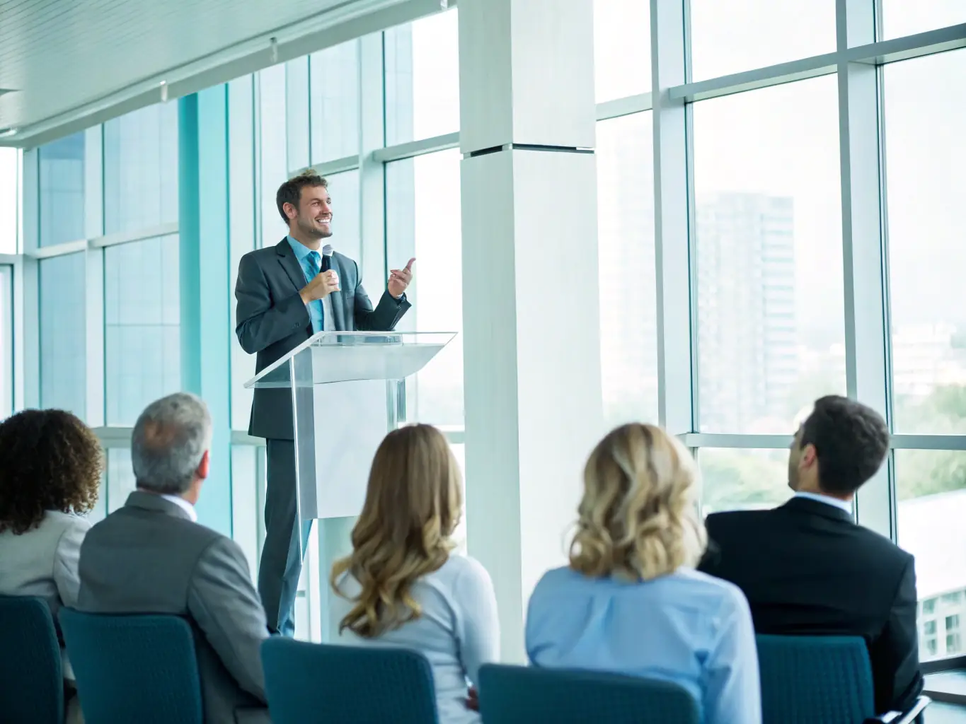 A dynamic image of a person confidently speaking in a professional setting with a UK cityscape in the background, representing the Confidence Building Program.
