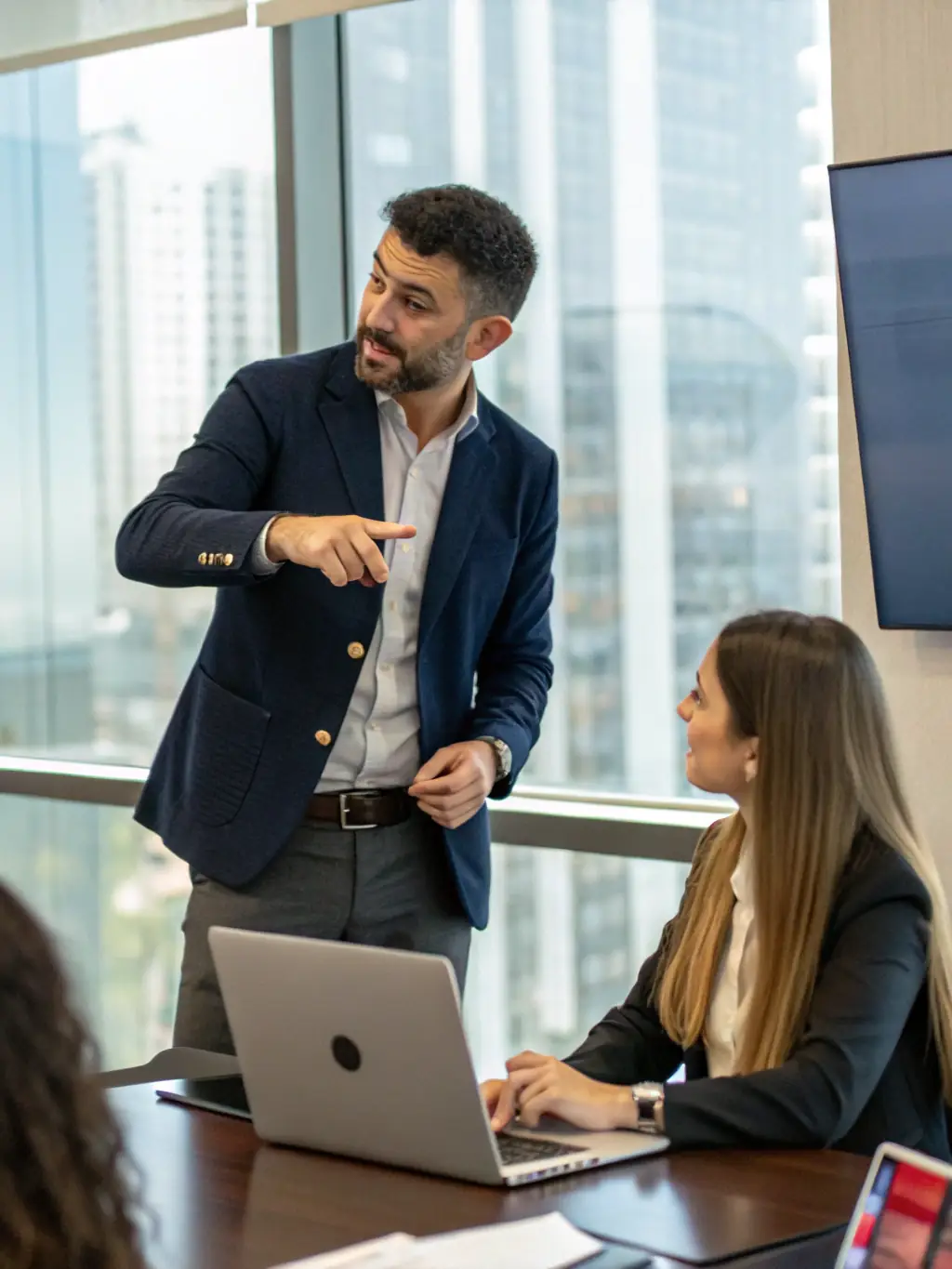 A person confidently presenting in a modern office setting, symbolizing personal development and leadership skills.